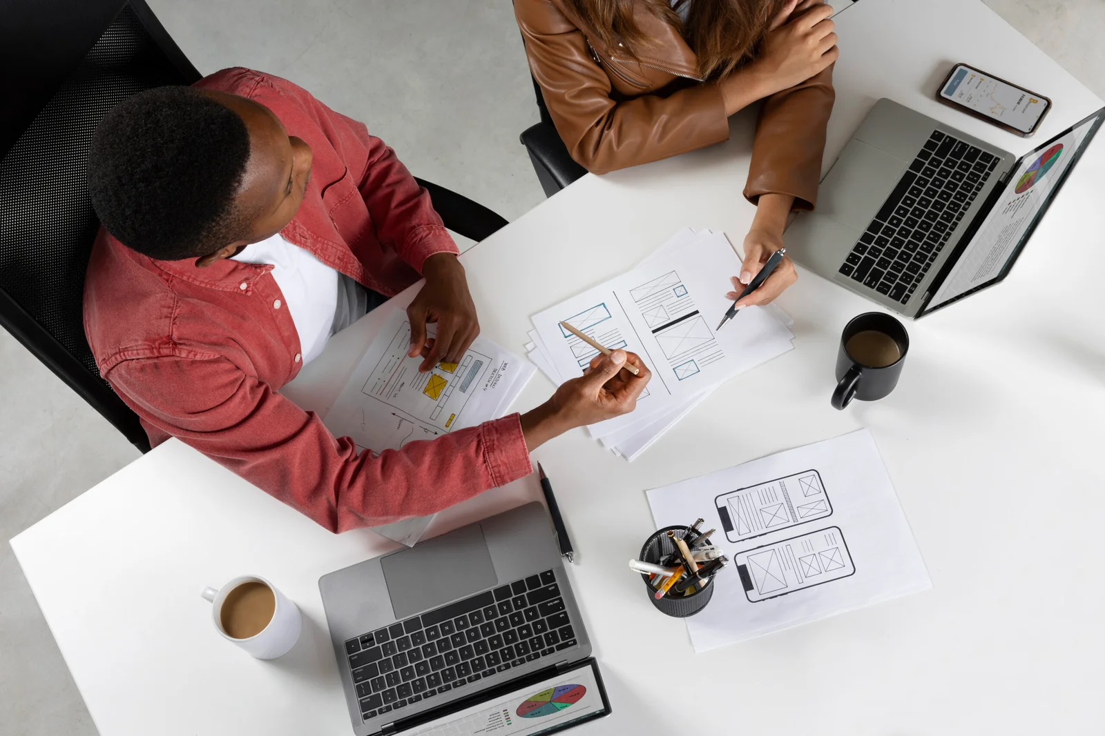 top-view-people-working-with-laptops-scaled